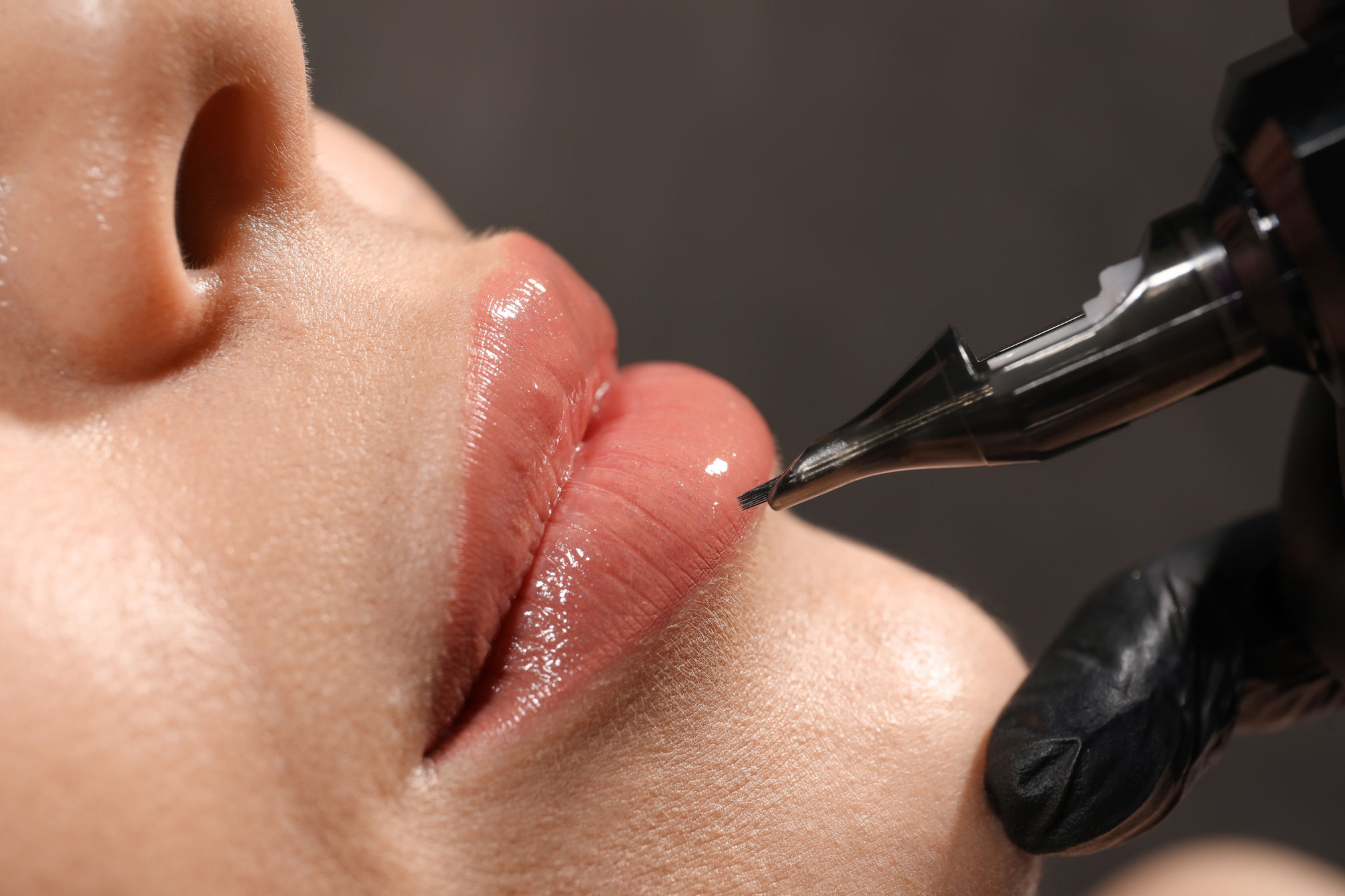 Young Woman Undergoing Procedure of Permanent Lip Makeup in Tatt